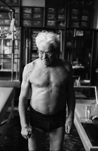 NEW YORK - OCTOBER 1961: Joe Pilates, Inventor, physical fitness guru and founder of the Pilates exercise method takes a break from his routine in his 8th Avenue studio on October 4, 1961 in New York City, New York. (Photo by I.C. Rapoport/Getty Images)